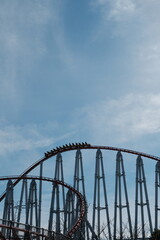 coaster ride in park, blue sky, go uphill