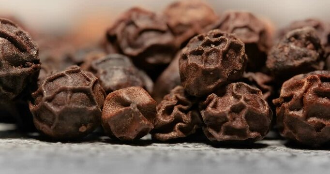 Peppercorns or black pepper spice. Super Macro Close Up.