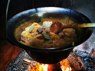 Cabbage in cooking kettle. Prepares traditional food cabbages with meat