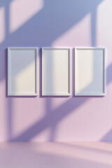 Set of three white frames on pastel pink wall