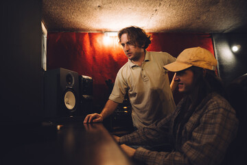 Musician and sound engineer in a recording studio.