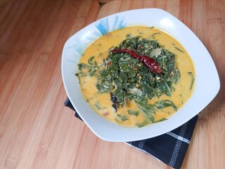 Indonesian traditional food 'Gulai Daun Singkong' or made from Tapioca or cassava leaves cooked...