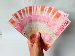 Cash payment concept. Indonesian rupiah currency (Rp. 100.000 Seratus Ribu Rupiah), One hundred thousand Indonesian rupiah money.