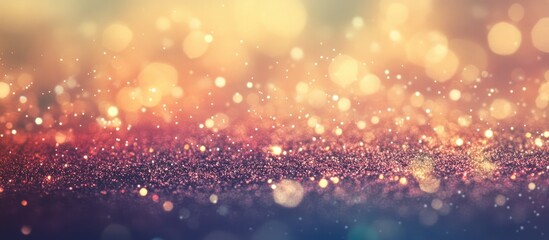 Fototapeta premium Elegant abstract background with warm bokeh lights and shiny glitter in shades of red and gold for festive and celebratory designs.