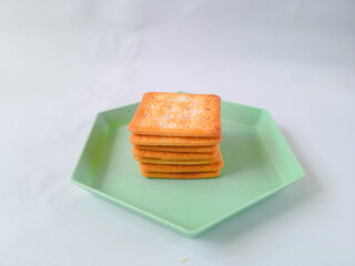 Sugar coated biscuits, also known as malkist, sweet and crispy. on a green hexagon plate isolate on...