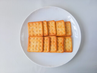 Sugar coated biscuits, also known as malkist, sweet and crispy. Served on white plate
