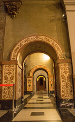 arched tunnel in the walls of the building, the walls are decorated with drawings