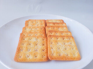 Sugar coated biscuits, also known as malkist, sweet and crispy. Served on white plate