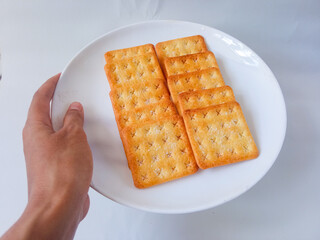 Sugar coated biscuits, also known as malkist, sweet and crispy. Served on white plate