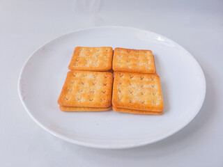 Sugar coated biscuits, also known as malkist, sweet and crispy. Served on white plate