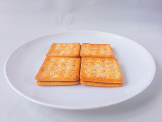 Sugar coated biscuits, also known as malkist, sweet and crispy. Served on white plate