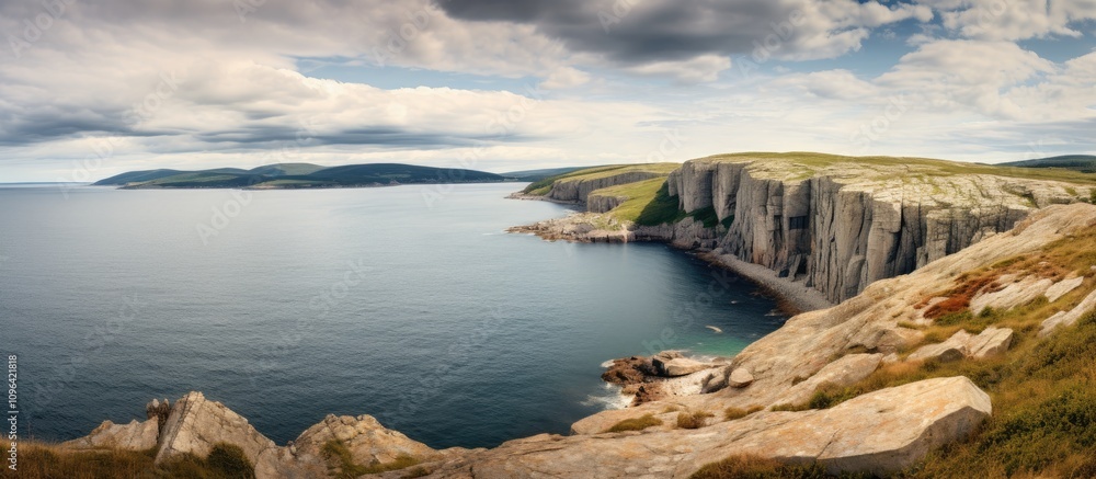 Aufkleber panoramic view of serene bay and dramatic rock cliffs under a cloudy summer sky showcasing natural b