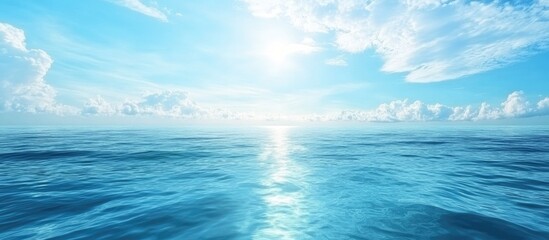 Fototapeta premium Serene ocean landscape with clear blue waters and a bright sky conveying peace and tranquility. Ideal for relaxation and wellness themes.