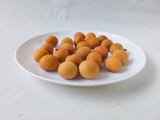 longan fruit on a white round plate isolate on white background