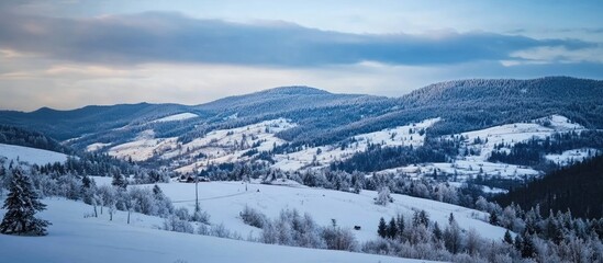 Serene winter landscape of snow-covered mountains and valleys under a clear blue sky showcasing the beauty of the winter season