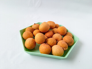 longan fruit on a green hexagon plate isolate on white background