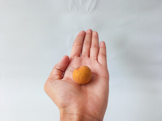 longan fruit held by asian woman hand isolate on white background