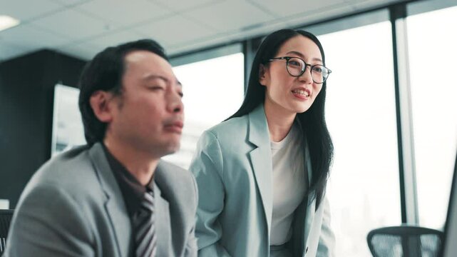 Japanese business people, computer and team training, help and problem solving. Collaboration, coaching and project discussion on pc for finance advice, sales feedback and intern learning with mentor