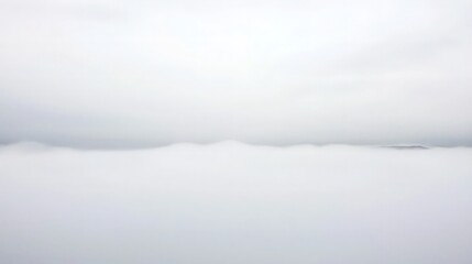 Fototapeta premium Misty landscape, ethereal view of cloudscape, subtle land below.
