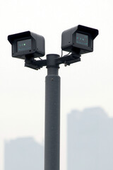 Urban air pollution monitoring devices on pole, capturing data on smog levels. These sensors play crucial role in assessing air quality in urban environments