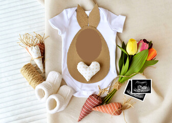 Easter baby Girl or boy Birth announcement template. Pregnancy announcement. Little Easter Bunny. mockup Blank white onesie and  booties.  flat lay. Spring baby birth announcement.
