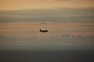 The plane is in the air against the blue sky. Close-up of the aircraft