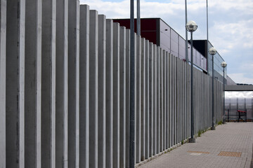 
construction of a building with a metal gate and lanterns in the middle