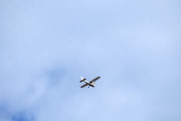 small plane in the sky on a blue background