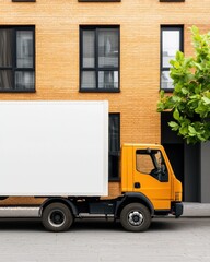 A bright yellow delivery truck parked next to a modern building with large windows and a tree, showcasing urban transportation and architecture.