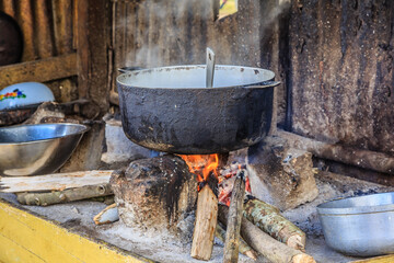 A pot of food is cooking on a fire