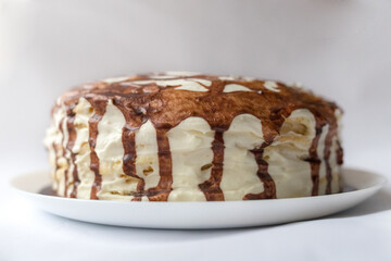 Chocolate pie Milchmadchen with cheese cream sauce with banana and cherry on the white background. Traditional German cake. Ready to eat.