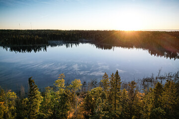 A lake with a beautiful sunset in the background