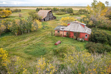 A rural area with a red house and a barn