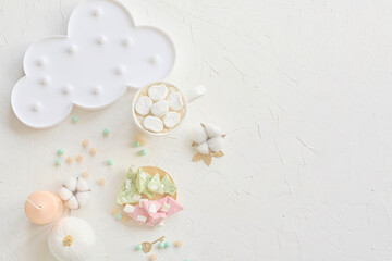 Charming pastel-colored dessert setup featuring marshmallows, a cloud plate, and decor on a white background.