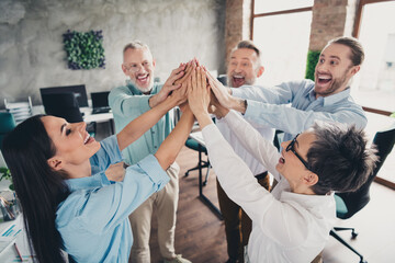 Photo of teamwork people working together raise hands support high five comfortable modern office...