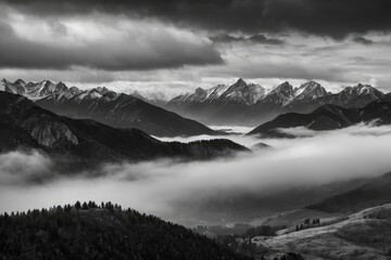 Obraz premium Awe-Inspiring Black and White Mountain Valley, Misty Peaks, and Dramatic Scenery