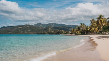 Obraz premium Serene beach with soft white sand, calm turquoise water, and a peaceful sky during a tranquil day by the sea.