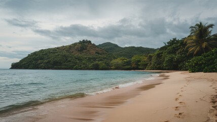 Serene beach with soft white sand, calm turquoise water, and a peaceful sky during a tranquil day by the sea.