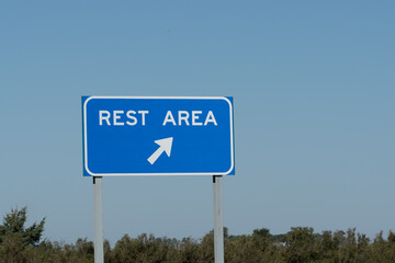 Blue Rest Area sign with bright blue sky in summer. Road trip travel concept image