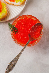 Red caviar in a caviar dish with a sprig of dill