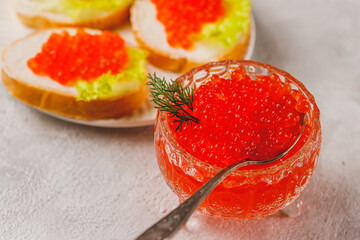 Red caviar in a caviar dish with a sprig of dill