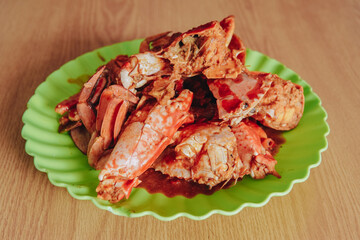 A plate of delicious crabs cooked with sweet and sour sauce in a seafood restaurant.