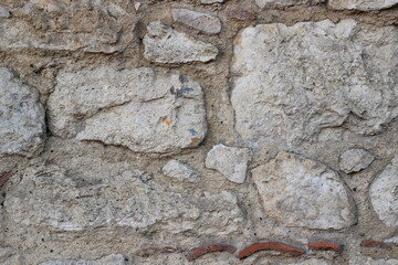 Background of gray stone masonry with a rough, textured surface. Suitable for architectural designs, construction-themed projects, or as a rustic background