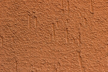 Close-up texture of reddish cement with a rough, pattern-free surface