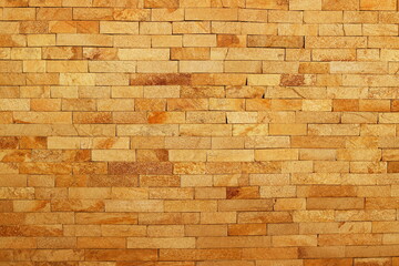 A decorative brick background in various shades of red, creating a warm and cozy atmosphere. Perfect for use in interiors, design, or as a texture for various projects.