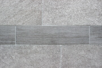 A close-up of a gray tile design with a textured surface