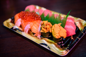 uni sushi with maguro sushi and salmon sushi set on desk, japanese food