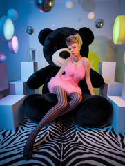 Beautiful model in retro pink dress. Fashion creative photo shoot. Fashionable avantgarde style photography for magazines.