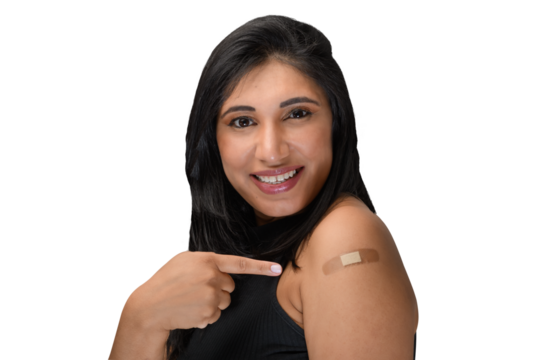 woman points to the vaccine sticker on her arm