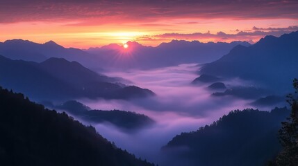 Obraz premium Stunning sunrise bathes the mountain peaks in a warm glow, while soft fog fills the valleys below, creating a peaceful and awe-inspiring landscape